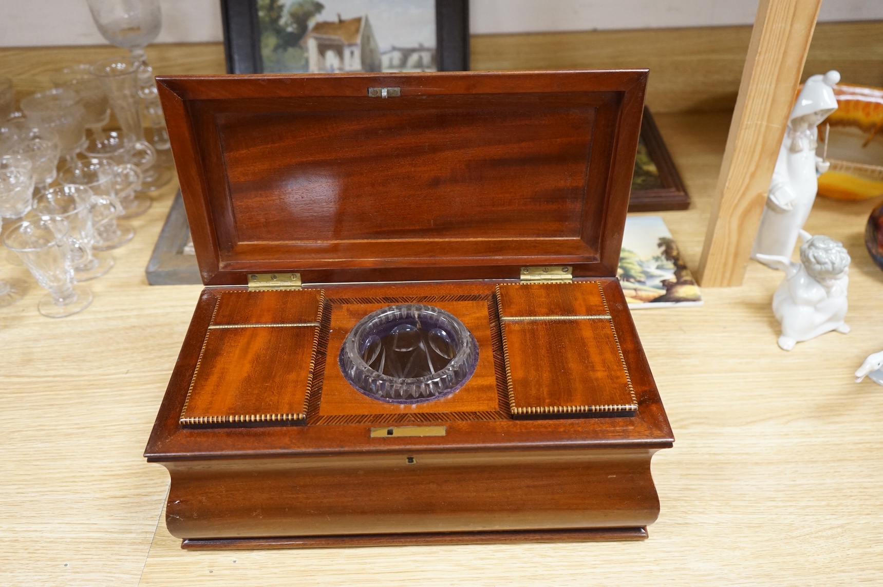 A 19th century mahogany sarcophagus tea caddy, with interior fittings, 35cm wide x 15.5cm high